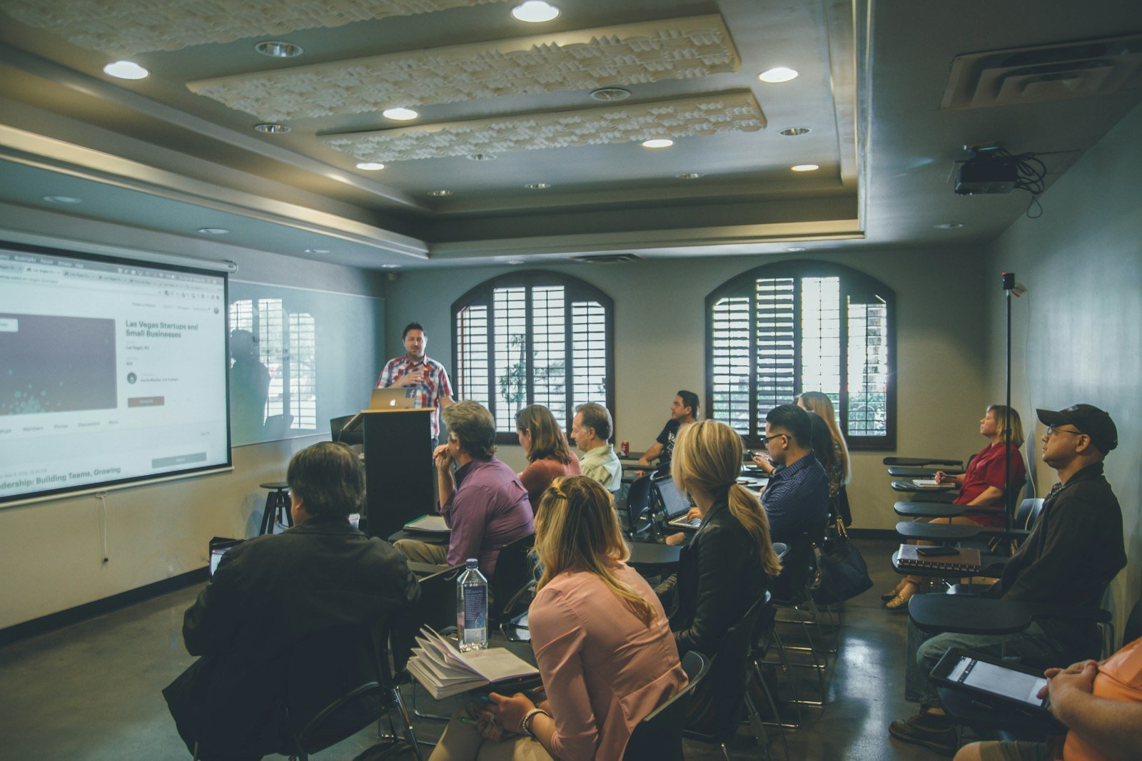 A trainer leading a class in a seminar room
